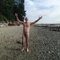 Old man naked beside the sea.