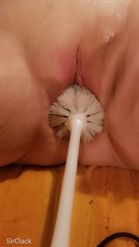 Using the brush in her pussy