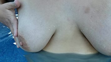 Playing with my boobs in the pool