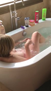 My wife in tub shaving her legs.