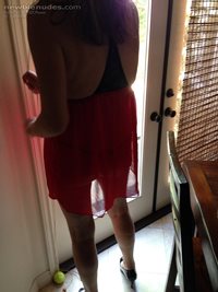 Standing in the window with only my thong, red nighty, and black heels in t...